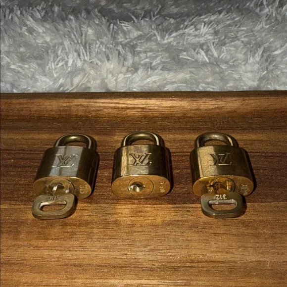 Louis Vuitton Gold Padlock Trio is available for purchase on  display picture 1